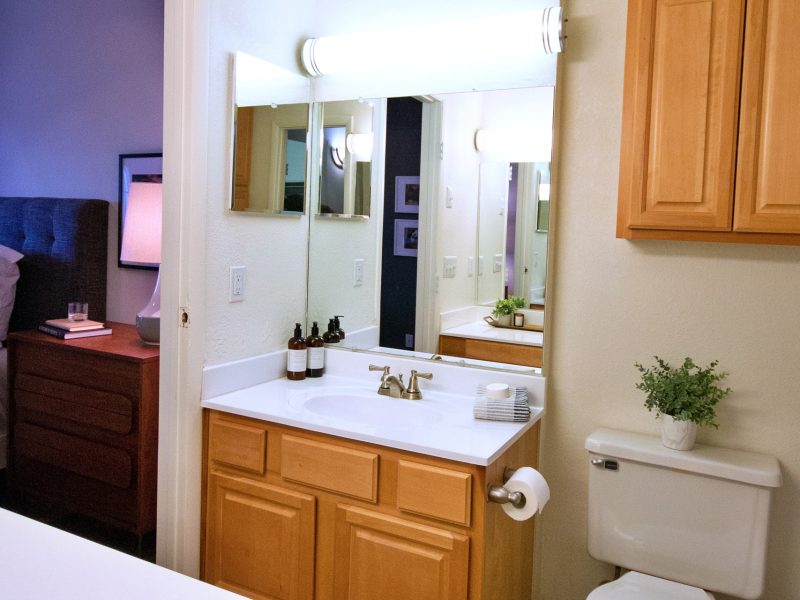 This image features an upgraded bathroom with clean countertops and modern brushed nickel fixtures.