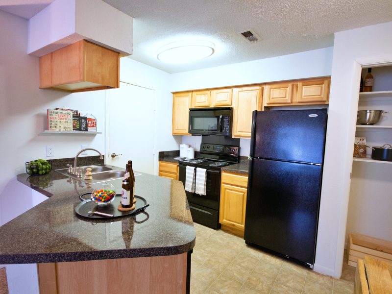 This image exhibits the premium apartment feature, particularly the kitchen island featuring a newly renovated kitchen with high-end details, a breakfast bar, and ceramic tile throughout the foyer.